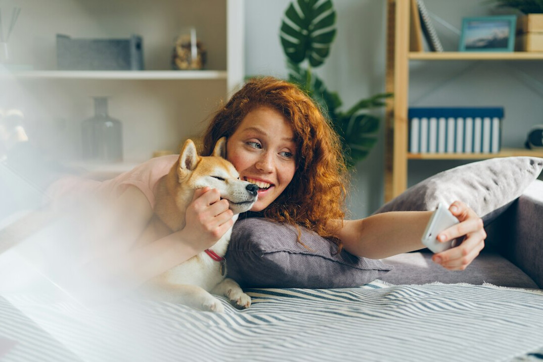 Young German woman streaming a show on a tablet at home